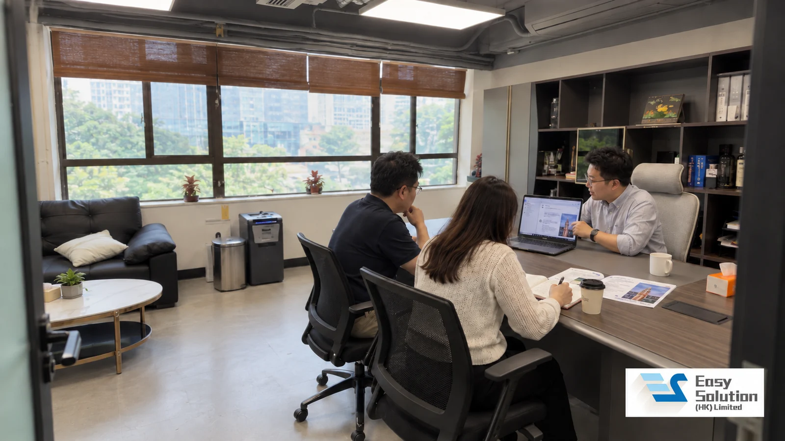 Easy Solution 會議室：導師與兩位學員圍坐木紋枱，以筆記型電腦進行小組教學